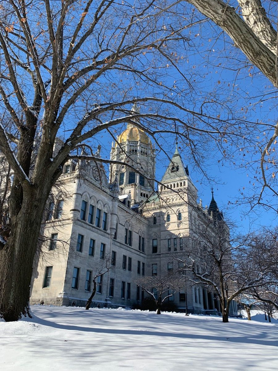 Angled photo of the CT state Capitol building in winter with snow on the ground