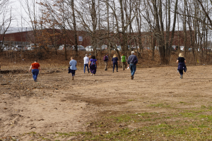 Save the Sound staff walk the site of a future rain garden at Hamden Town Center Park